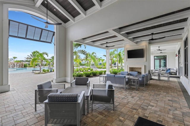 view of patio featuring an outdoor living space with a fireplace