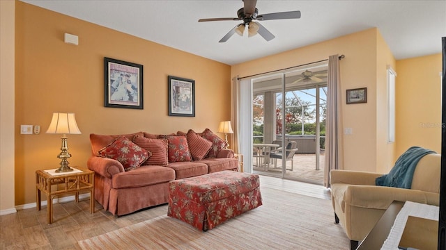 living room with ceiling fan and light hardwood / wood-style flooring