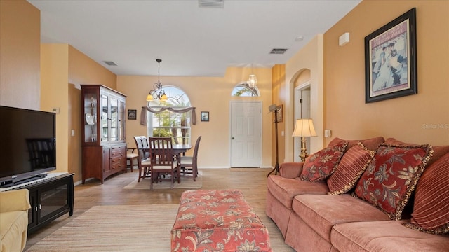 living room featuring hardwood / wood-style floors and a notable chandelier