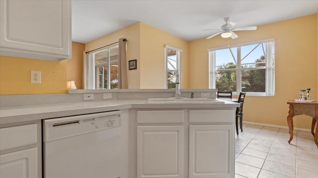 kitchen featuring white dishwasher, white cabinetry, ceiling fan, and light tile patterned flooring