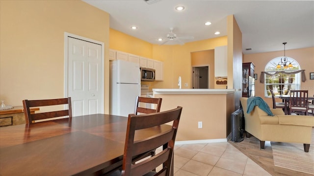 dining room with light tile patterned floors and ceiling fan