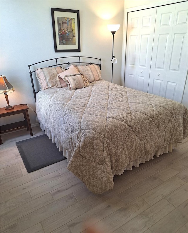 bedroom featuring a closet and light hardwood / wood-style flooring