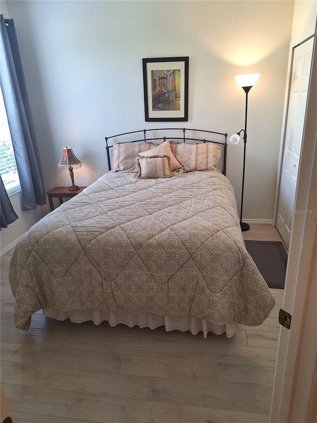 bedroom with hardwood / wood-style floors