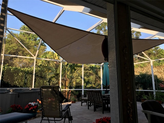 wooden deck featuring a lanai, a patio area, and a hot tub