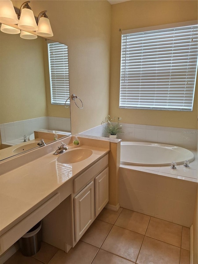 bathroom featuring vanity, tiled tub, and tile patterned floors