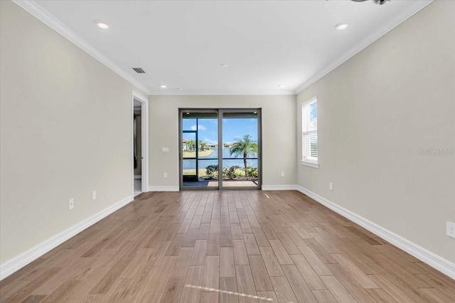 unfurnished room featuring light wood-type flooring and ornamental molding