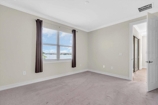 carpeted spare room with ornamental molding