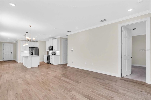 unfurnished living room featuring light wood-type flooring, a chandelier, and ornamental molding