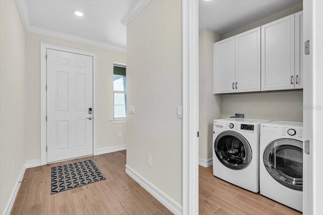 washroom featuring light wood-type flooring, cabinets, crown molding, and independent washer and dryer