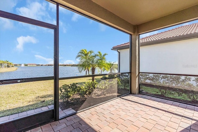 unfurnished sunroom with a water view