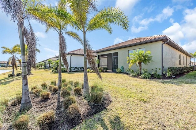 rear view of house featuring a lawn