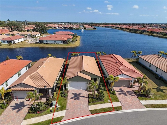 birds eye view of property with a water view