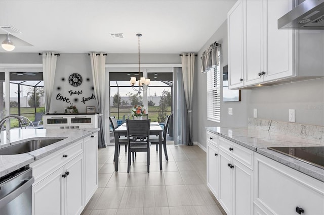 kitchen featuring a sink, stainless steel dishwasher, exhaust hood, and visible vents