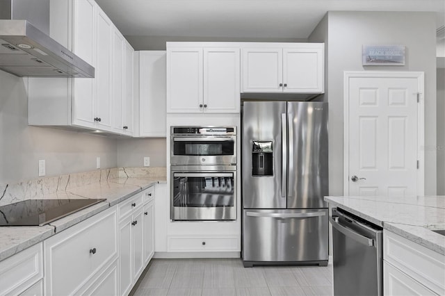 kitchen featuring wall chimney range hood, appliances with stainless steel finishes, and white cabinets