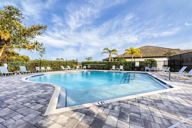 community pool featuring a patio area and fence