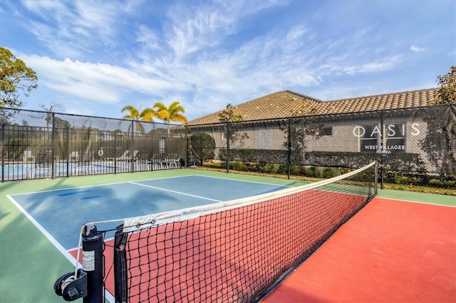 view of sport court featuring fence