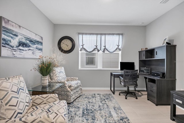 home office featuring baseboards and light tile patterned floors