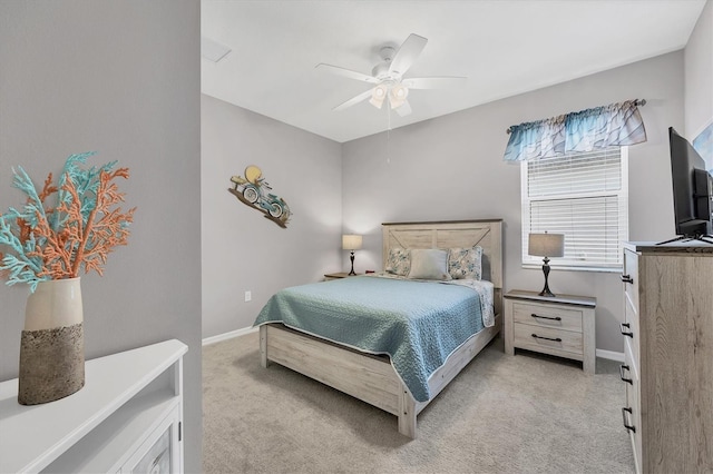 bedroom with light carpet, ceiling fan, and baseboards