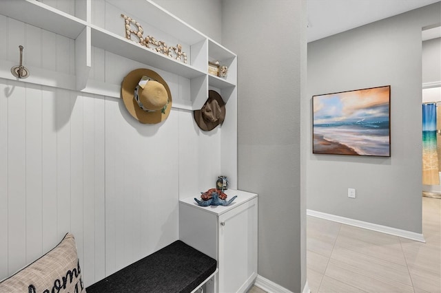 mudroom with baseboards and light tile patterned flooring