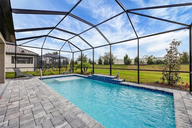 outdoor pool featuring glass enclosure, a patio, and a lawn