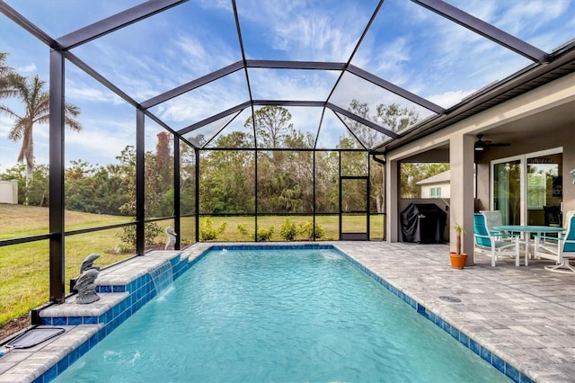 pool featuring a patio area, a lanai, and a ceiling fan