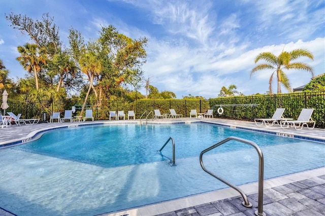 community pool featuring fence and a patio