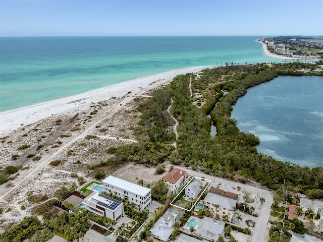 drone / aerial view with a water view and a beach view