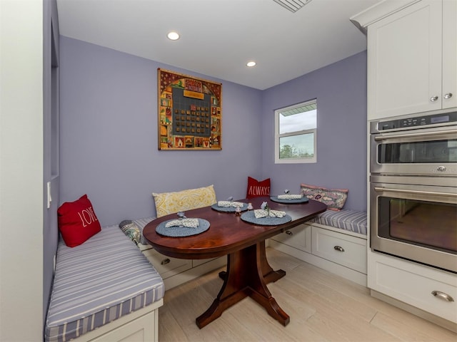 dining space with light hardwood / wood-style floors and breakfast area