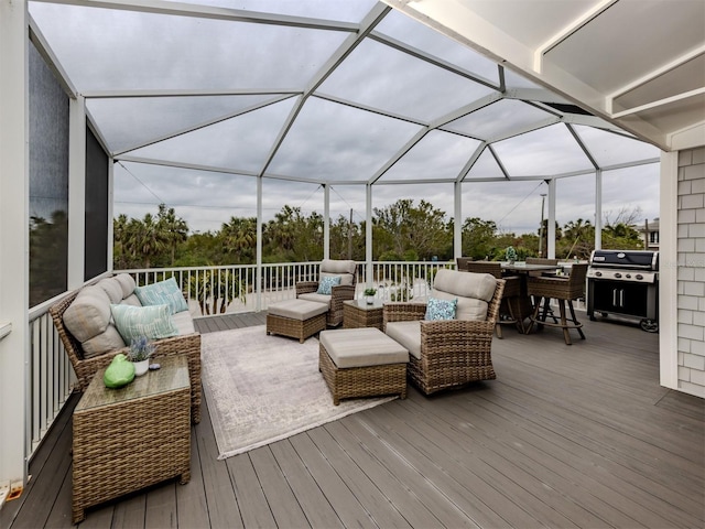 wooden terrace featuring glass enclosure, outdoor lounge area, and area for grilling