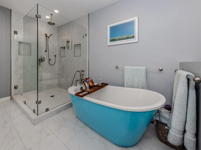 bathroom featuring separate shower and tub