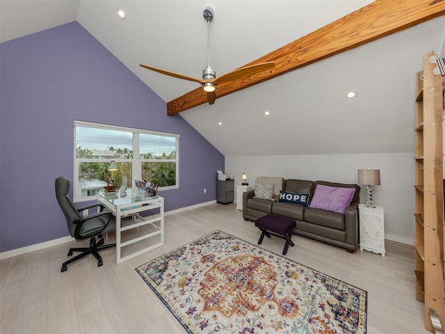 home office with light hardwood / wood-style floors and vaulted ceiling with beams