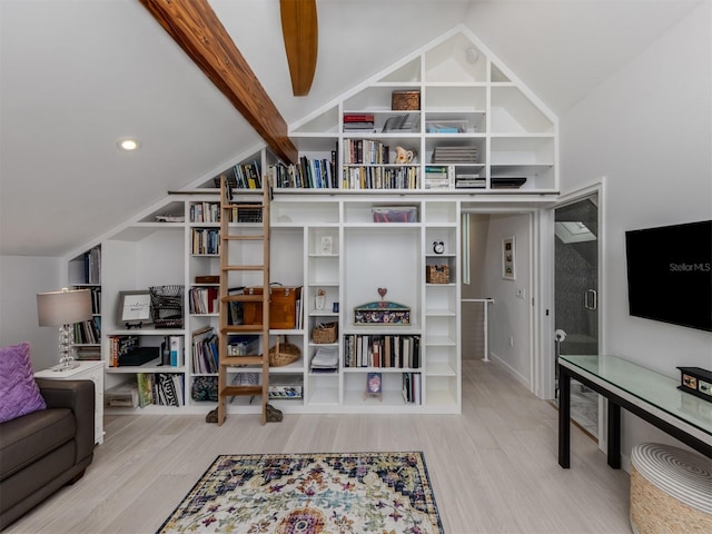 interior space featuring wood-type flooring and lofted ceiling with beams