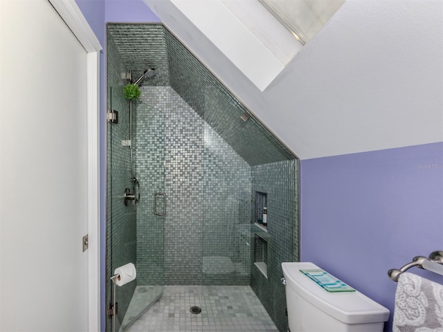 bathroom featuring toilet and walk in shower