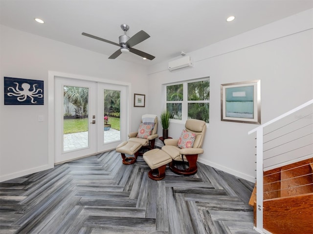 sitting room with a wall mounted AC, dark parquet floors, french doors, and a healthy amount of sunlight