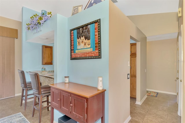 hall featuring light tile patterned flooring