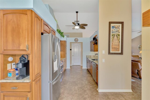 kitchen featuring ceiling fan, stainless steel appliances, and light tile patterned floors