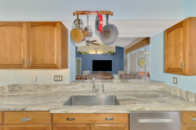 kitchen featuring lofted ceiling, sink, dishwasher, ceiling fan, and kitchen peninsula