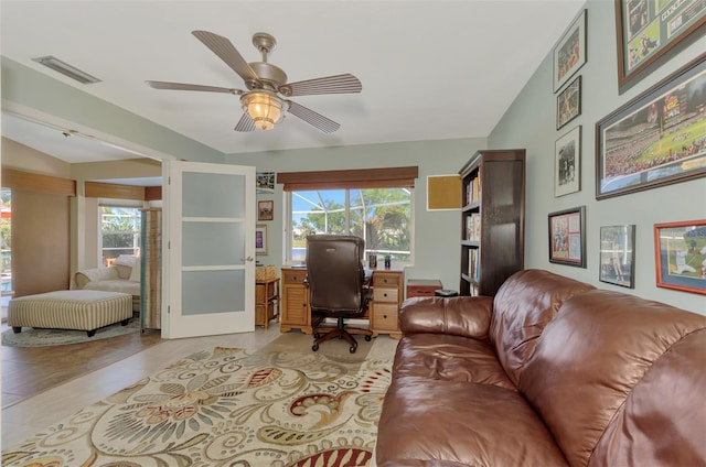 office space with lofted ceiling and ceiling fan