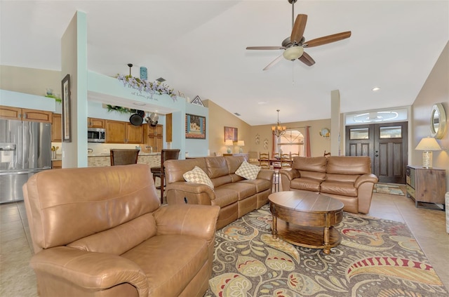 living room featuring light tile patterned floors, ceiling fan with notable chandelier, and vaulted ceiling