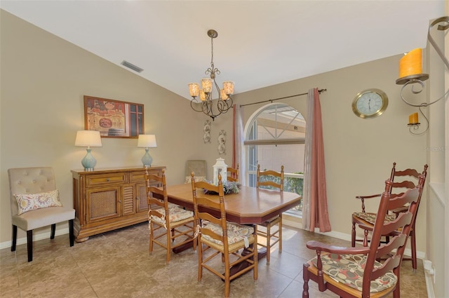 tiled dining room with lofted ceiling and a chandelier