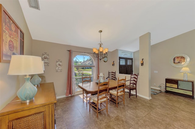 dining space with visible vents, baseboards, and a chandelier