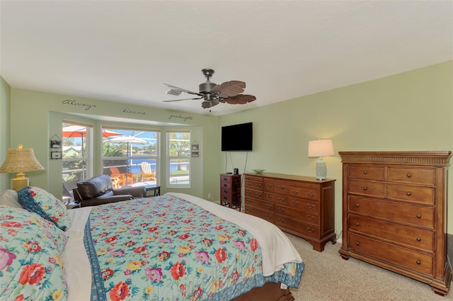 bedroom with light carpet and a ceiling fan
