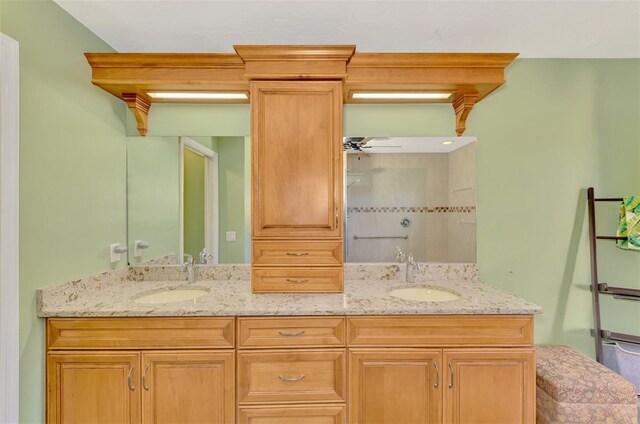 full bathroom featuring double vanity, a sink, and a ceiling fan