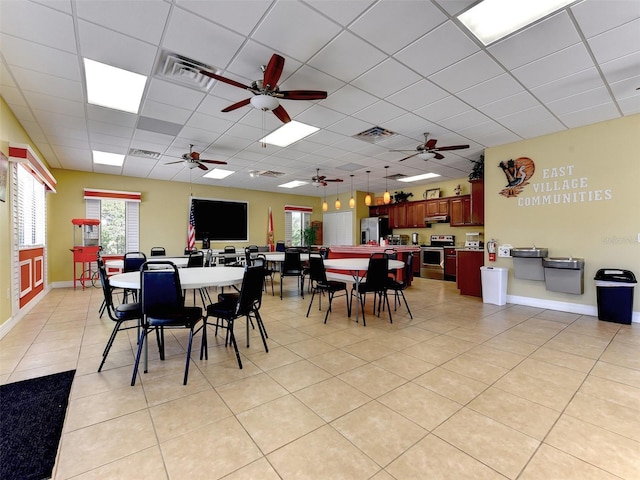 dining area featuring ceiling fan, a paneled ceiling, and visible vents