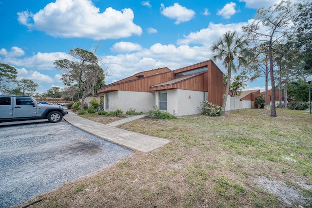 view of side of home with a yard