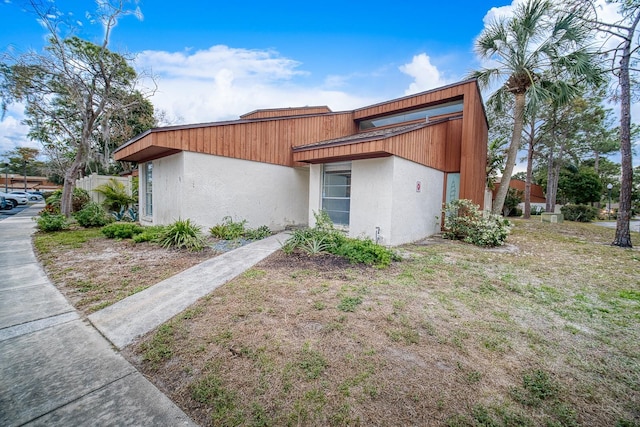 view of property exterior with a lawn