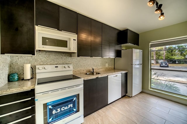 kitchen featuring sink, tasteful backsplash, and white appliances