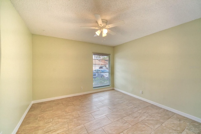 tiled spare room featuring a textured ceiling and ceiling fan