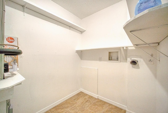 washroom featuring a textured ceiling and hookup for a washing machine