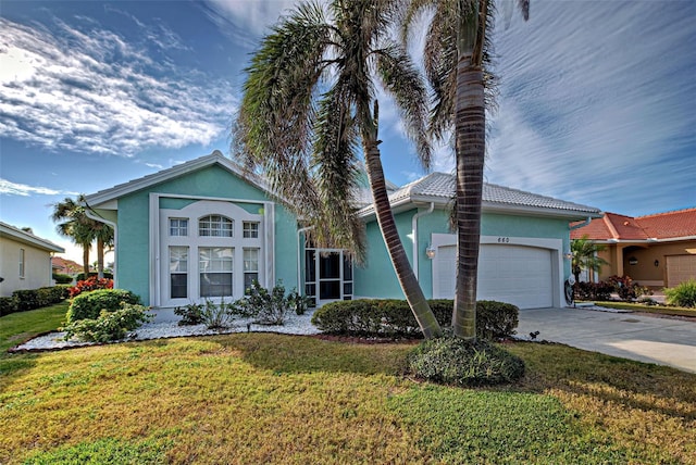 view of front facade with a garage and a front yard